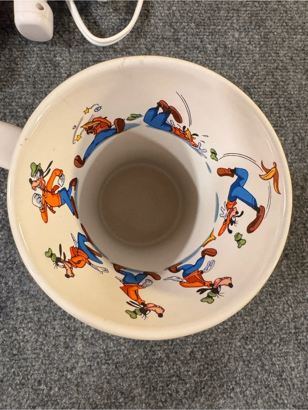 Vintage Disney store Goofy slipping on a banana peel.